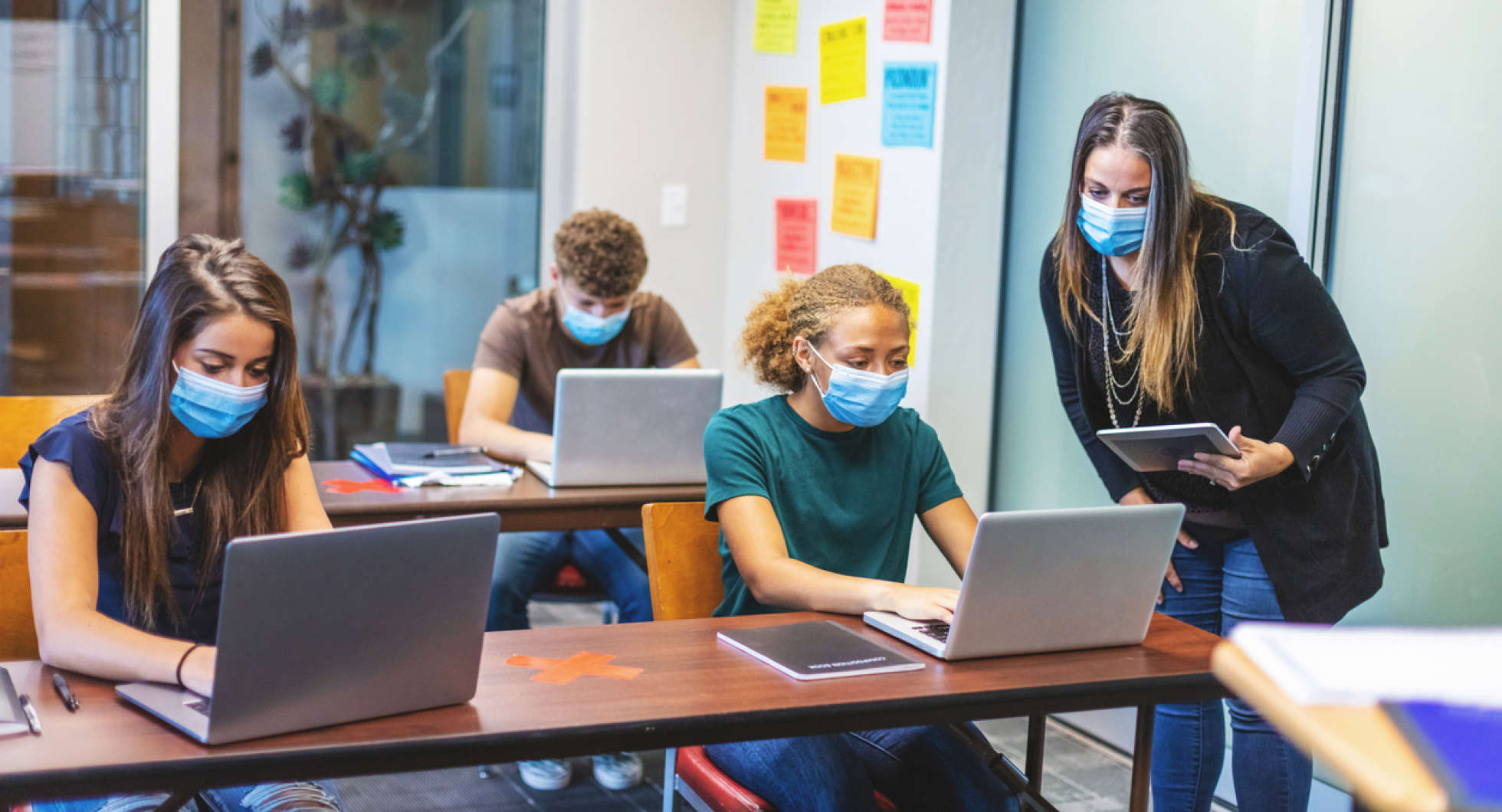 Students in a socially distanced classroom following the IB Diploma program